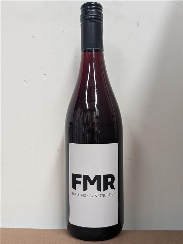 A wine bottle labeled Fox Metal Roofing β’ Construction against a plain background.