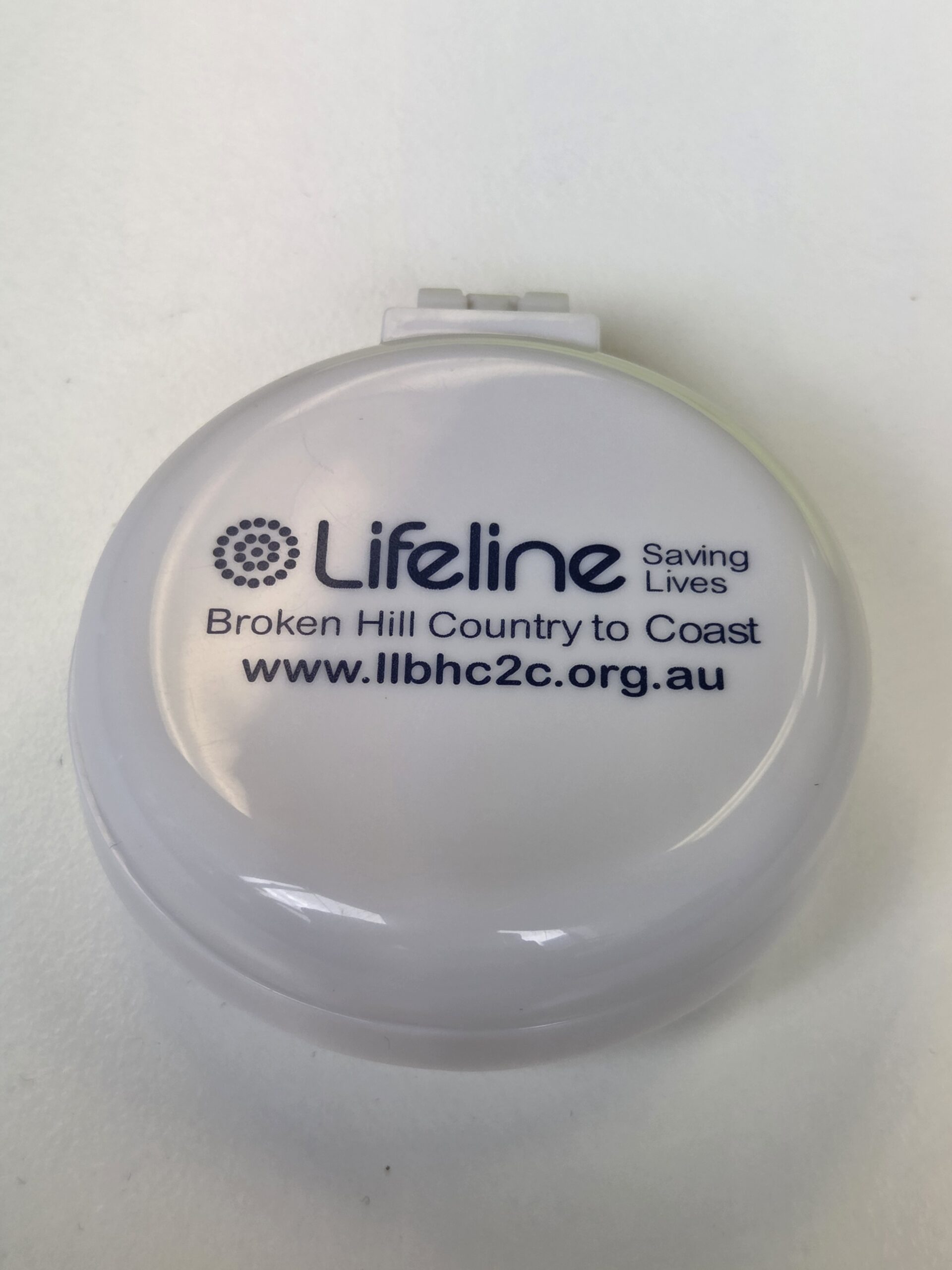 Round white tape measure with Lifeline logo and website: www.llbhc2c.org.au.