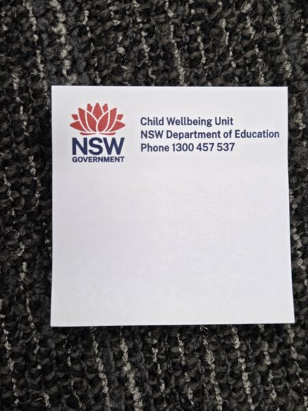 White note with NSW Government logo, ideal for event clean-up info at large gatherings