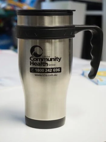 Silver travel mug with Latrobe Community Health Service logo—great for advising clients on the go.