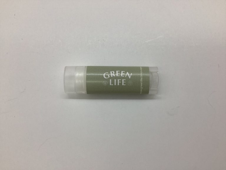 A tube of GREEN LIFE lip balm, one of our top reordered wellness items, on a white background.