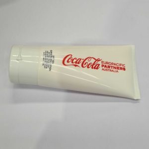 White tube labeled Coca-Cola Europacific Partners Australia used by account managers on a plain surface.