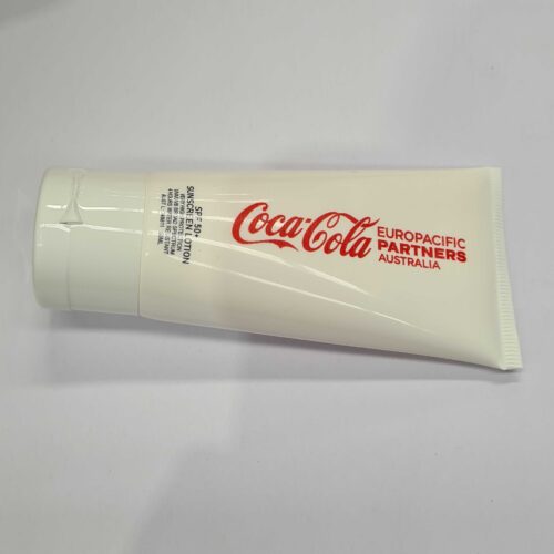 White tube labeled Coca-Cola Europacific Partners Australia used by account managers on a plain surface.